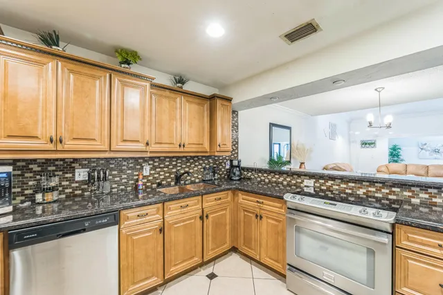 a kitchen with granite countertop a sink and cabinets