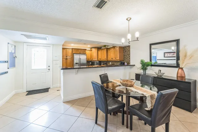 a dining room with granite countertop a table and chair