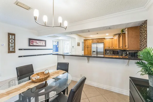 a living room with stainless steel appliances kitchen island granite countertop furniture and a kitchen view