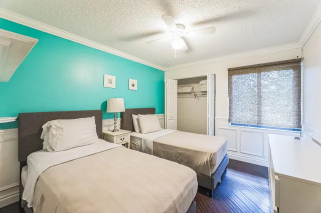 a bedroom with two beds and a window