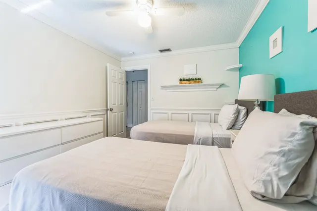 a bedroom with a bed and a potted plant