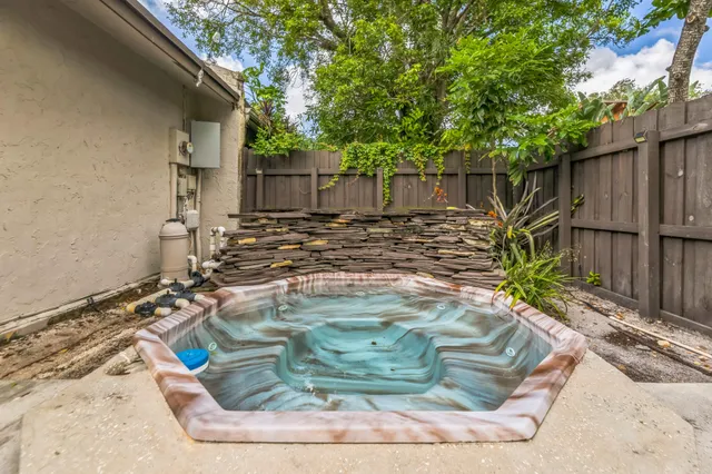 a view of a backyard with wooden fence