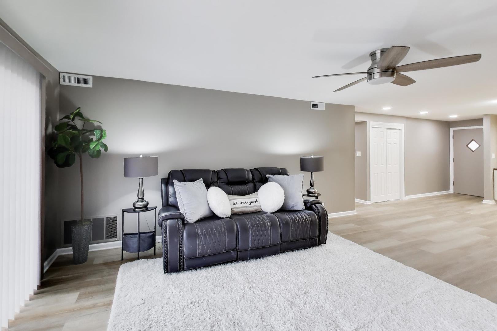 22 North Pistakee Lake Road, Unit 3E Fox Lake, IL 60020 - Photo 9 of 27 a bedroom with a large bed and a chandelier