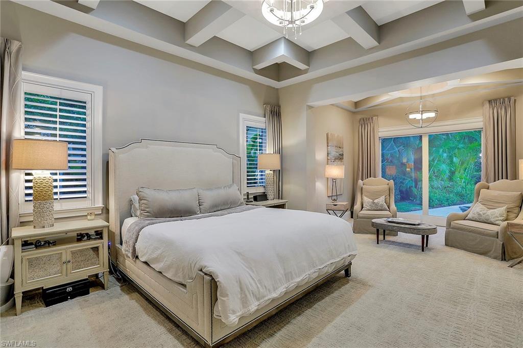 16776 Brightling Way Naples, FL 34110 - Photo 14 of 35 a bedroom with a bed and large windows