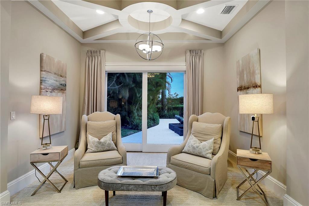16776 Brightling Way Naples, FL 34110 - Photo 15 of 35 a living room with furniture a lamp and a large window