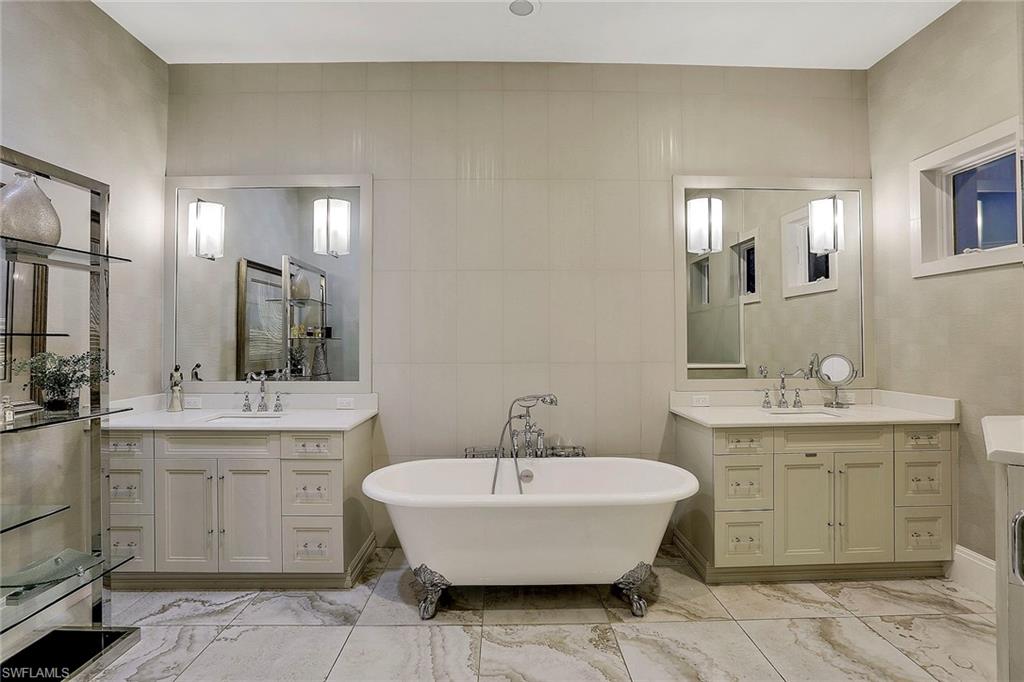 16776 Brightling Way Naples, FL 34110 - Photo 16 of 35 a spacious bathroom with a tub sink and mirror