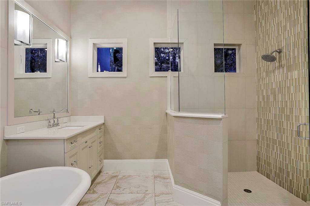 16776 Brightling Way Naples, FL 34110 - Photo 17 of 35 a bathroom with a sink a toilet and shower