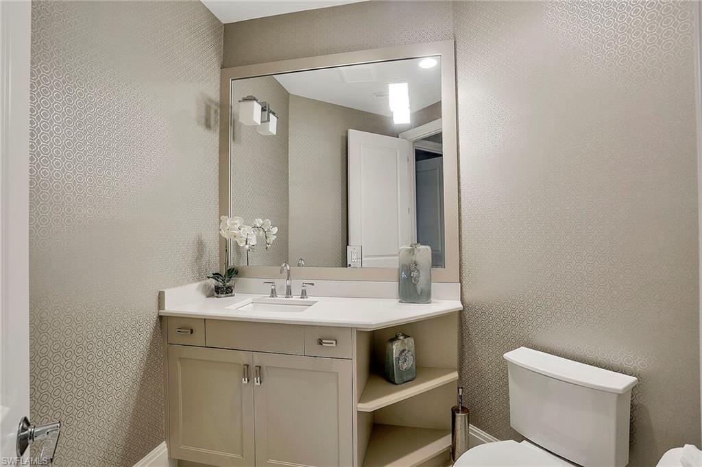 16776 Brightling Way Naples, FL 34110 - Photo 20 of 35 a bathroom with a sink and a mirror