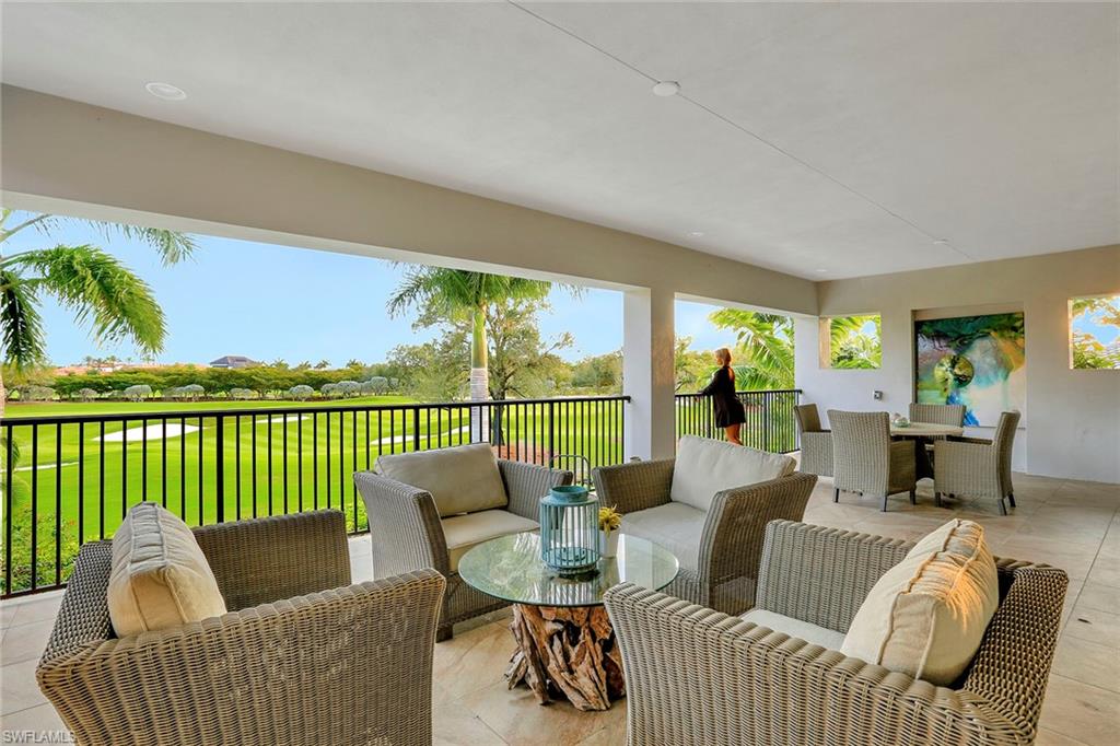 16776 Brightling Way Naples, FL 34110 - Photo 22 of 35 a living room with furniture and a floor to ceiling window