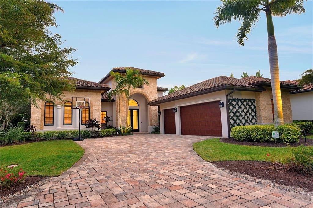 16776 Brightling Way Naples, FL 34110 - Photo 30 of 35 a front view of a house with a garden and yard