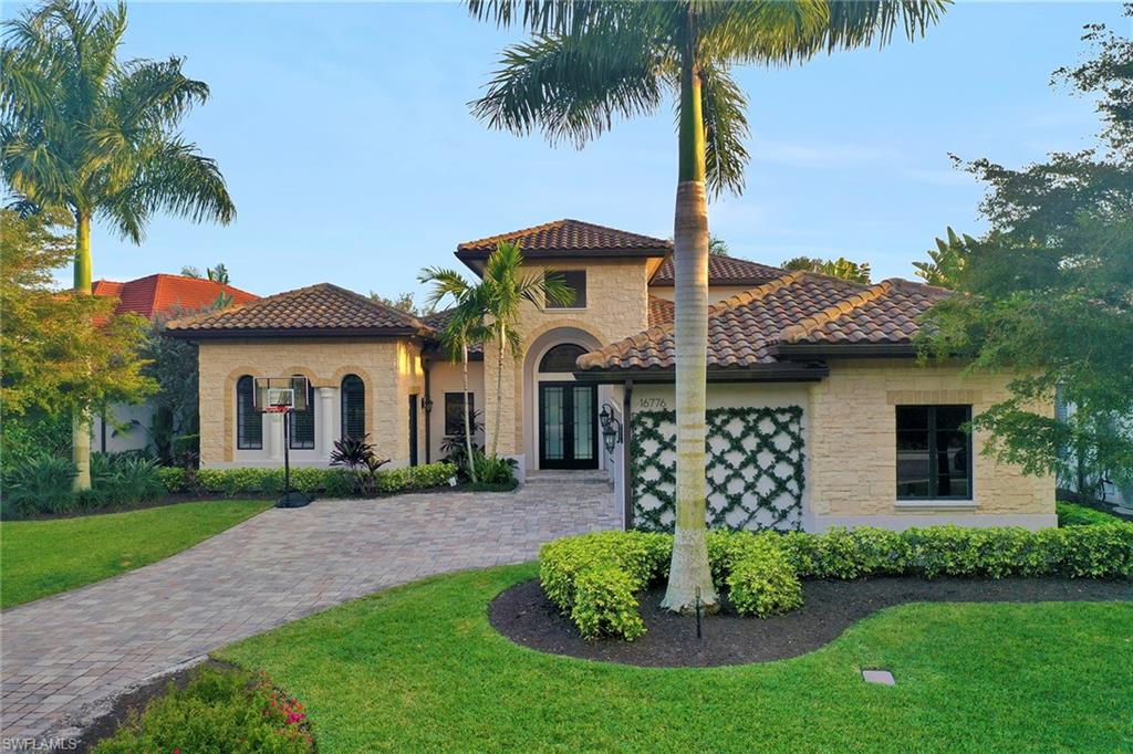 16776 Brightling Way Naples, FL 34110 - Photo 31 of 35 a front view of a house with a garden