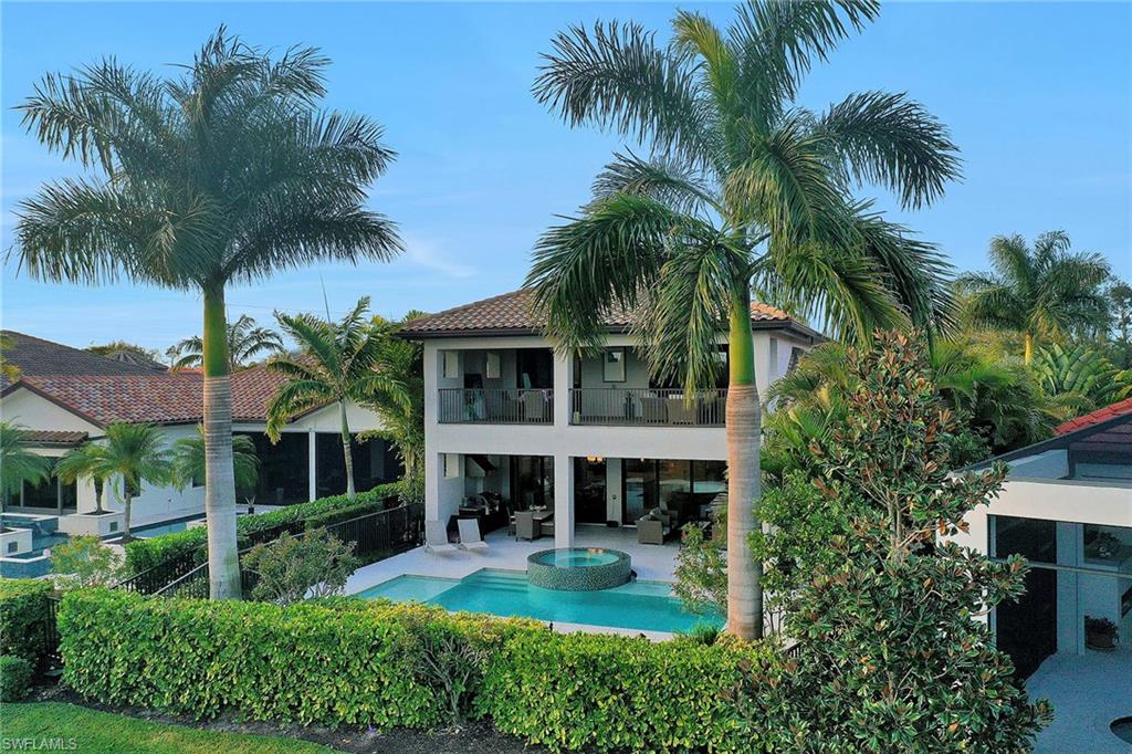 16776 Brightling Way Naples, FL 34110 - Photo 33 of 35 a view of a house with a swimming pool and a garden