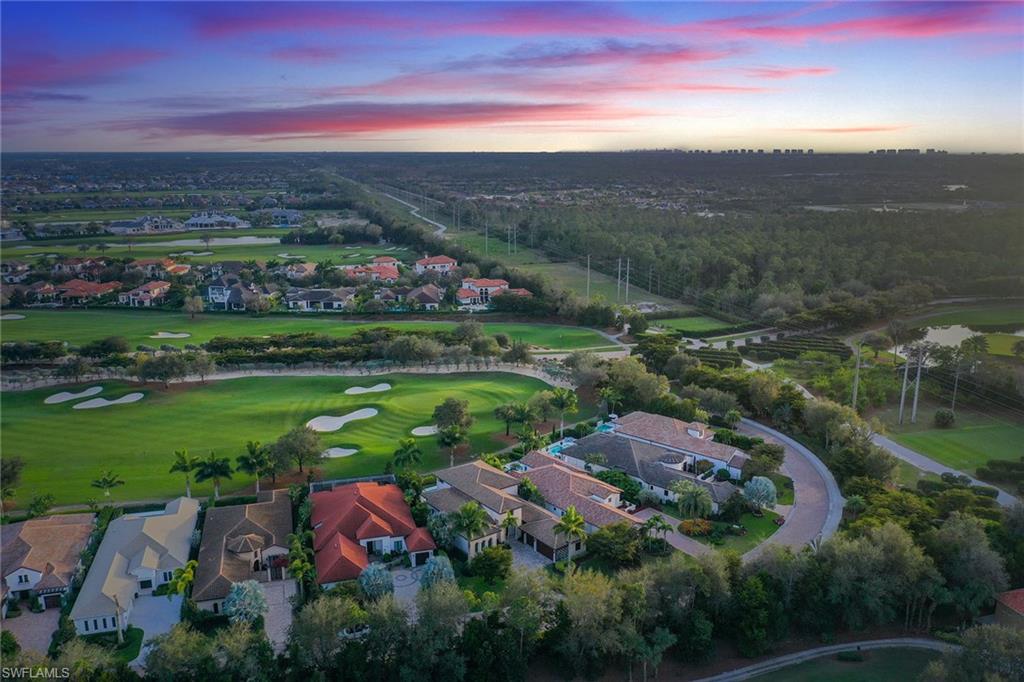16776 Brightling Way Naples, FL 34110 - Photo 34 of 35 an aerial view of a city with lots of residential buildings and mountain view in back
