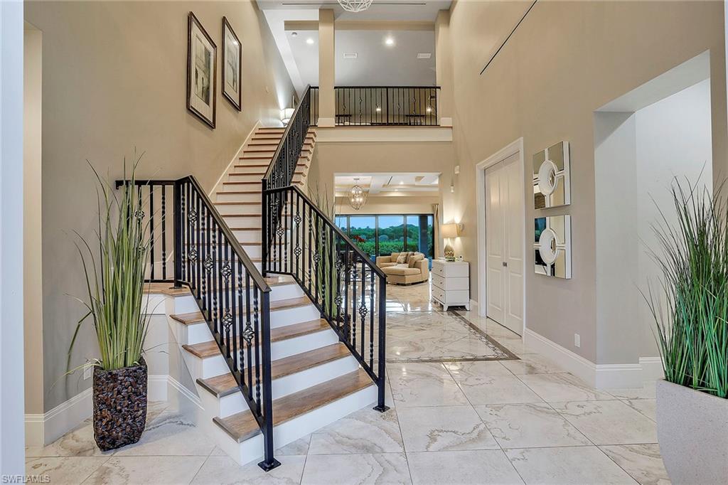 16776 Brightling Way Naples, FL 34110 - Photo 4 of 35 a view of staircase with lots of frames on wall and stairs