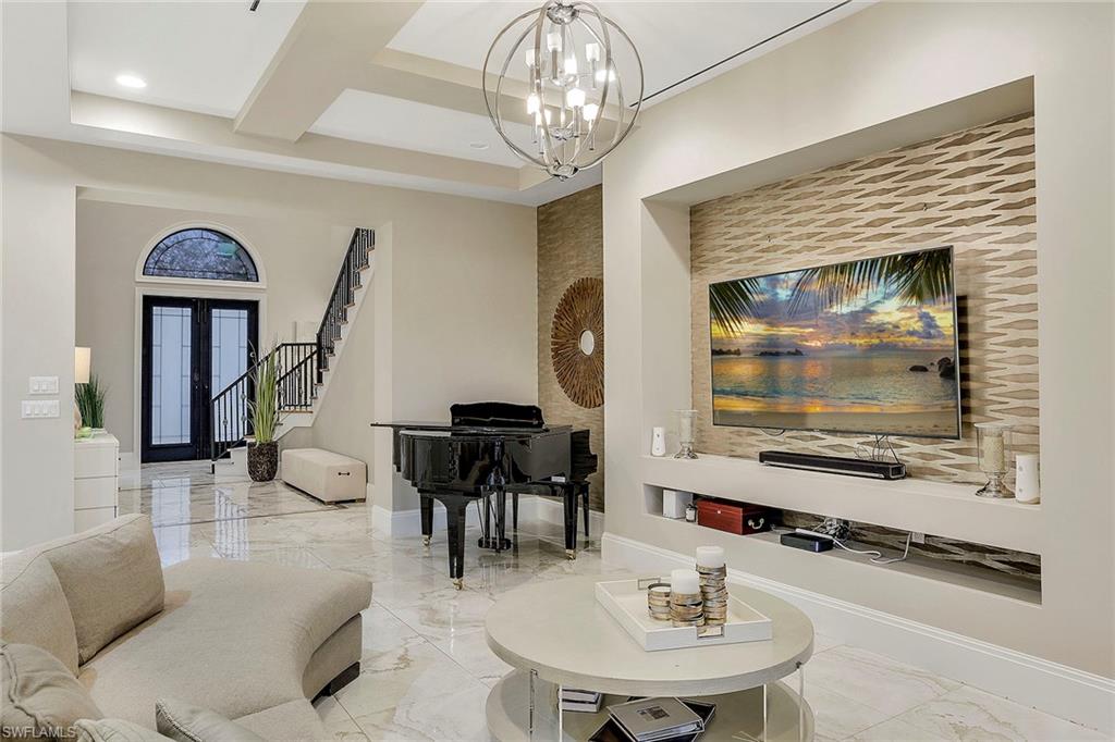 16776 Brightling Way Naples, FL 34110 - Photo 7 of 35 a dining room with furniture and a chandelier