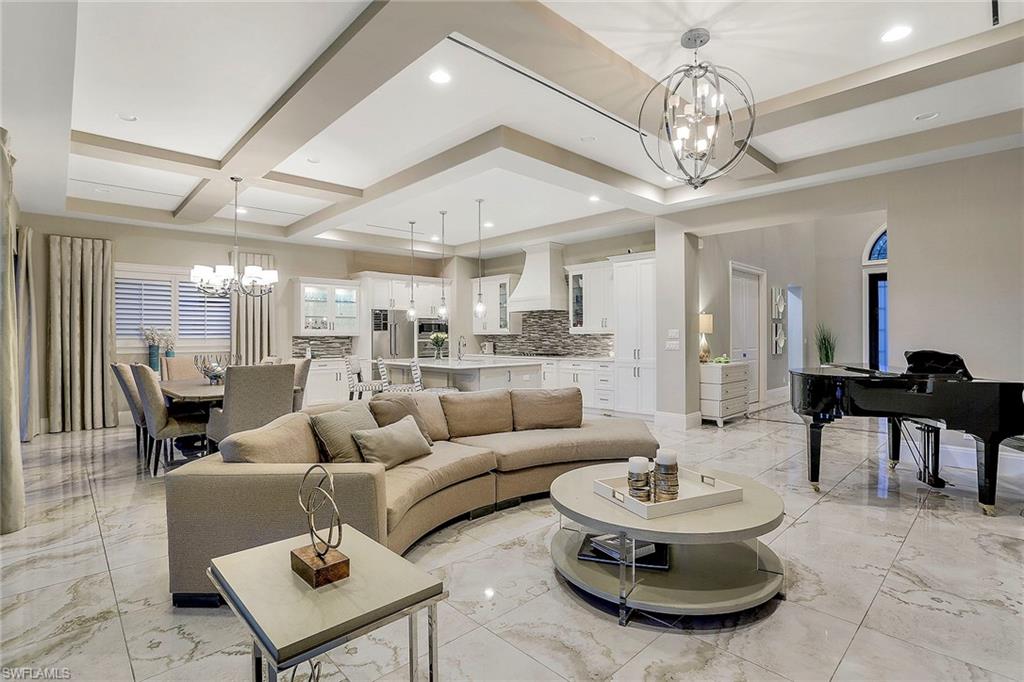16776 Brightling Way Naples, FL 34110 - Photo 8 of 35 a living room with furniture and a chandelier