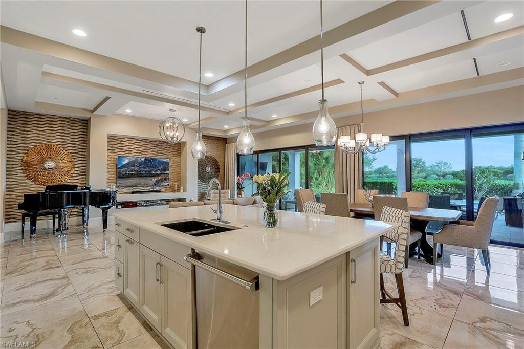 16776 Brightling Way Naples, FL 34110 - Photo 9 of 35 a kitchen with stainless steel appliances granite countertop a sink and cabinets