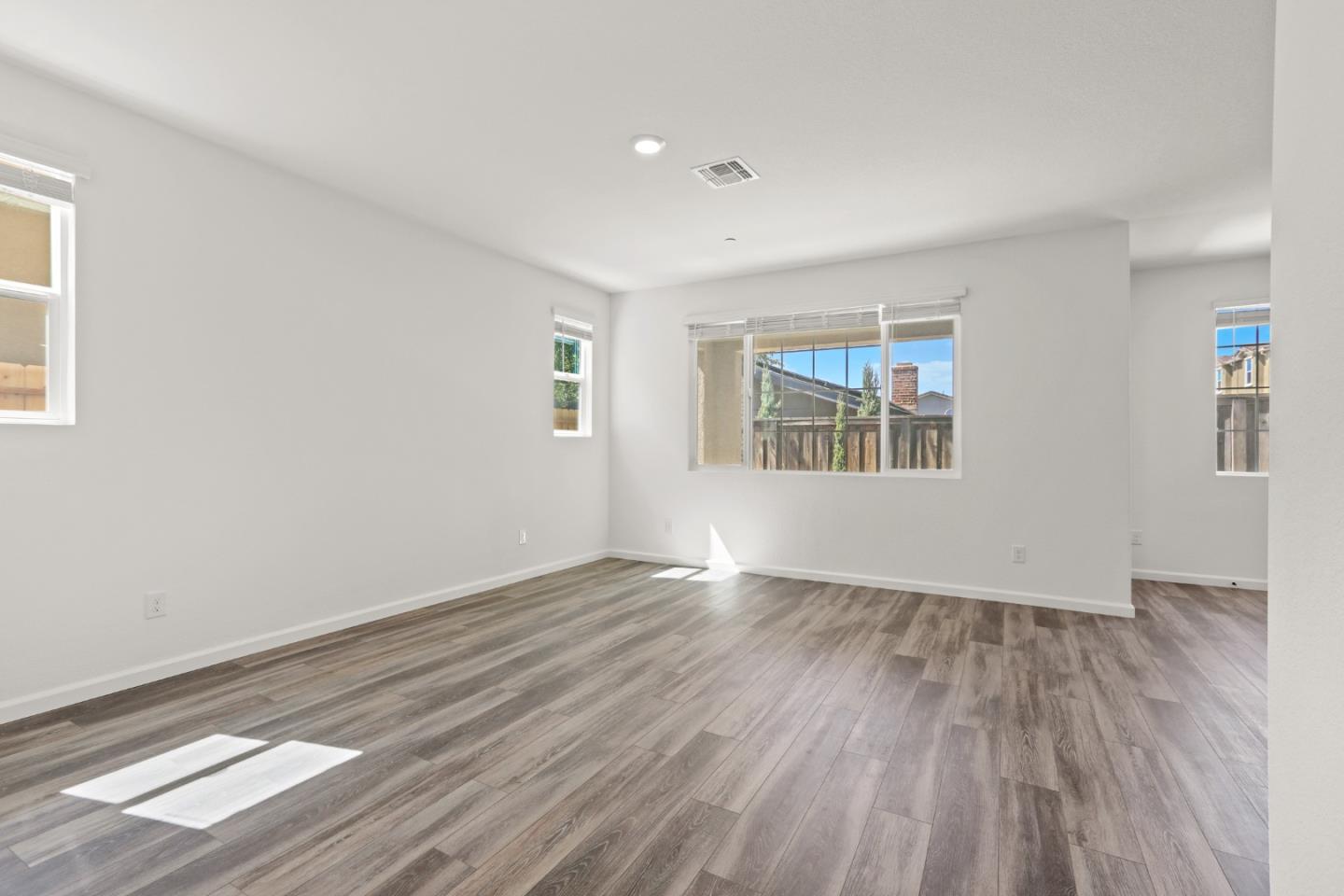 4503 Gray Lodge Loop Rocklin, CA 95677 - Photo 8 of 35 an empty room with wooden floor and windows