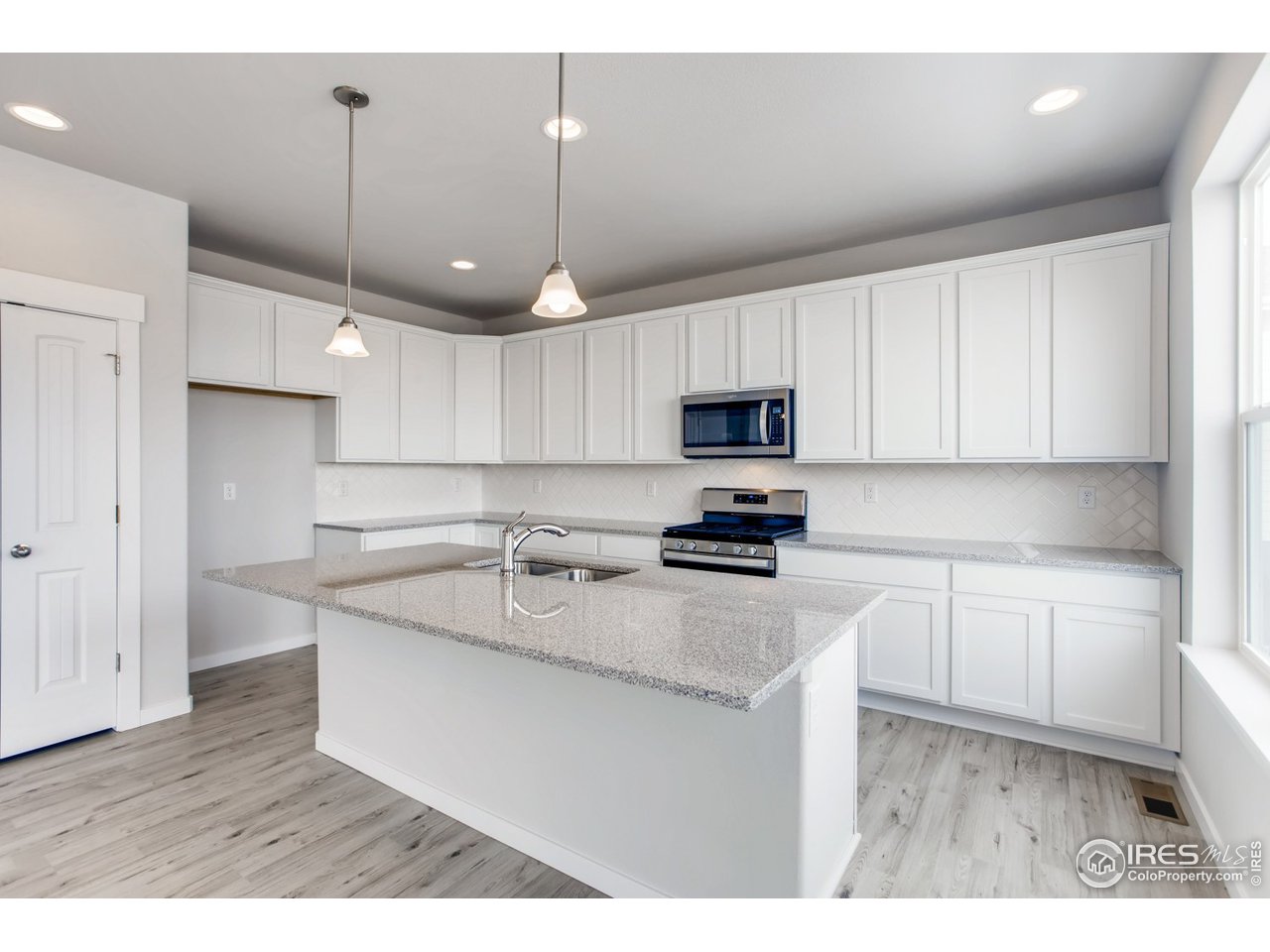 796 Lowry Lane Berthoud, CO 80513 - Photo 14 of 28 a kitchen with stainless steel appliances granite countertop a sink a stove a refrigerator and cabinets
