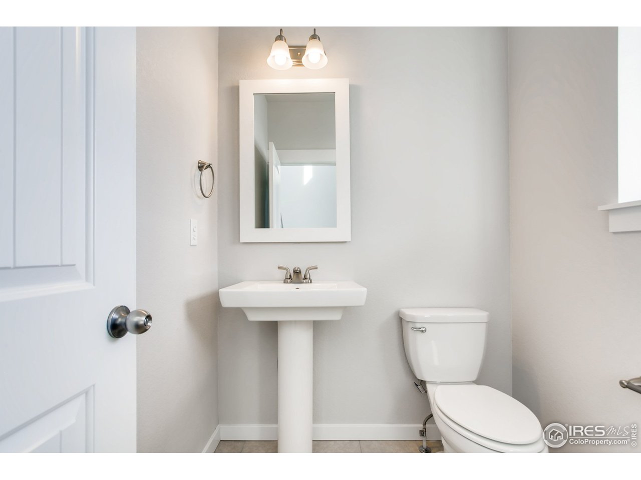 796 Lowry Lane Berthoud, CO 80513 - Photo 16 of 28 a bathroom with a toilet a sink and mirror