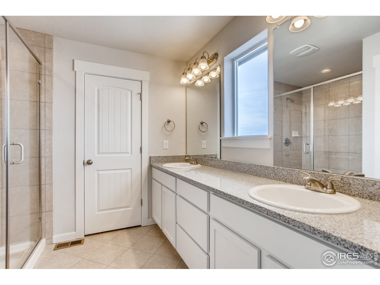 796 Lowry Lane Berthoud, CO 80513 - Photo 19 of 28 a bathroom with a granite countertop sink mirror and a shower