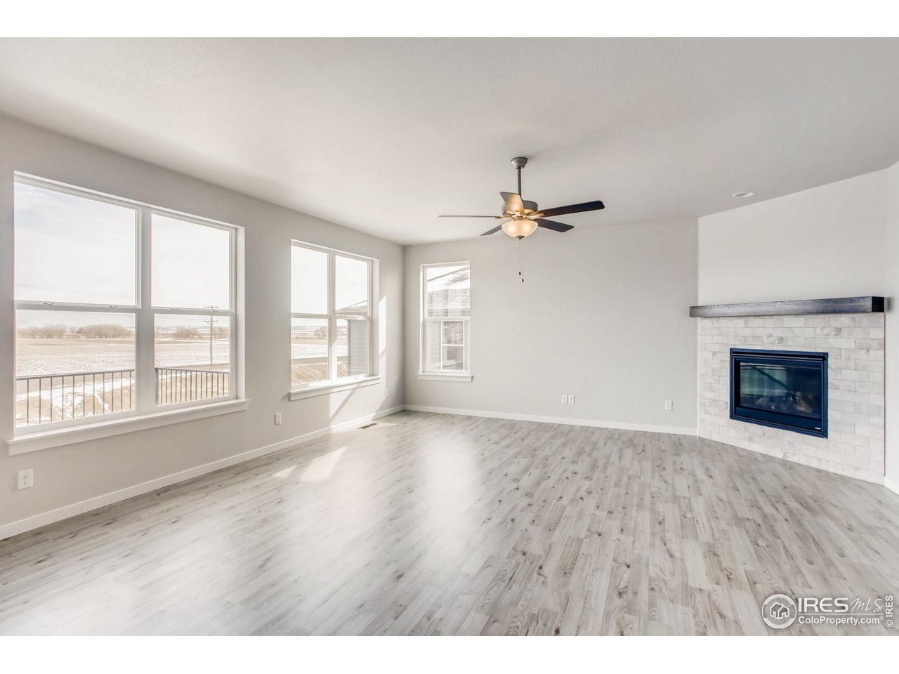 796 Lowry Lane Berthoud, CO 80513 - Photo 7 of 28 a view of an empty room with a window and wooden floor