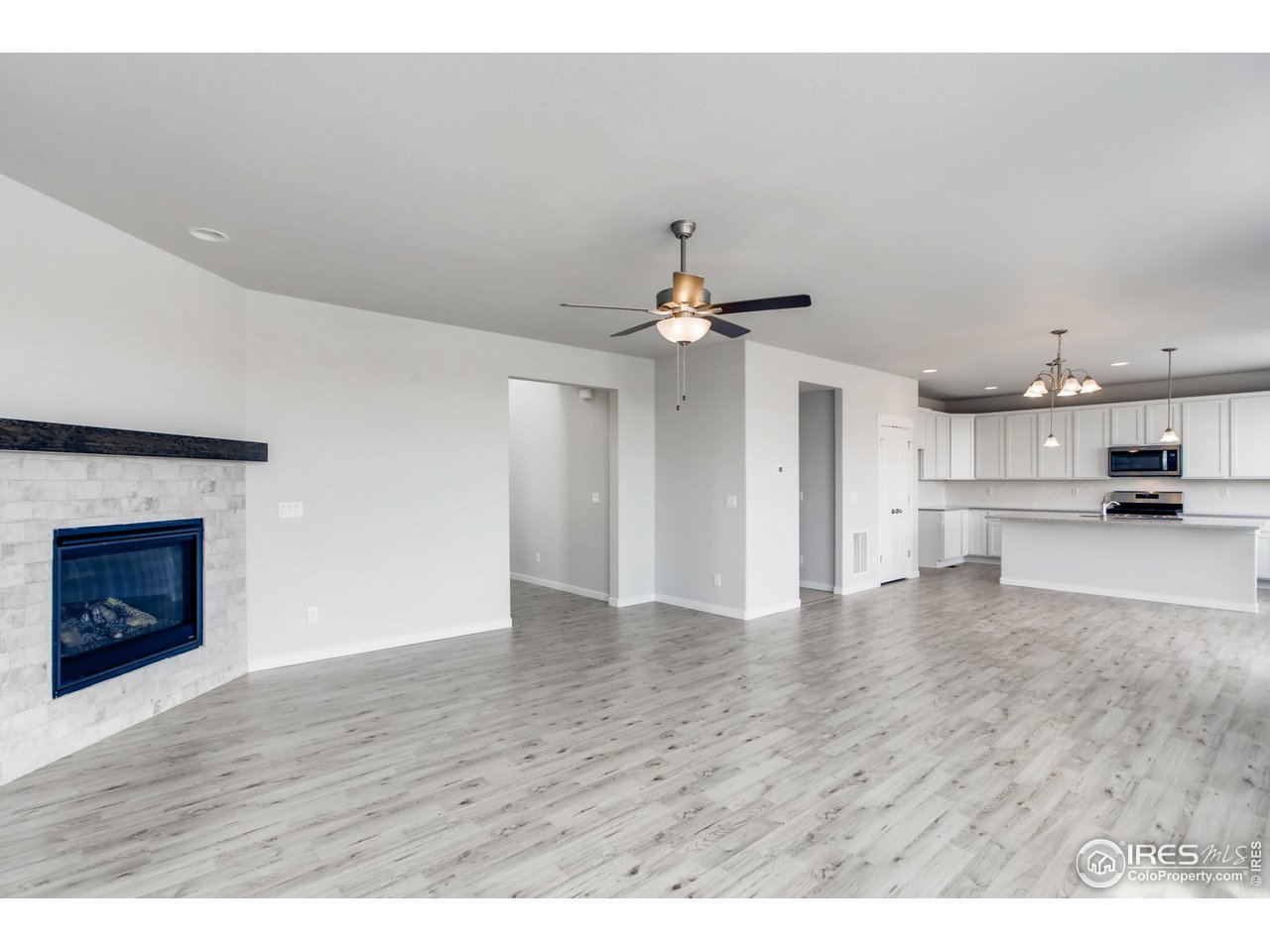 796 Lowry Lane Berthoud, CO 80513 - Photo 9 of 28 a view of kitchen and hall with wooden floor