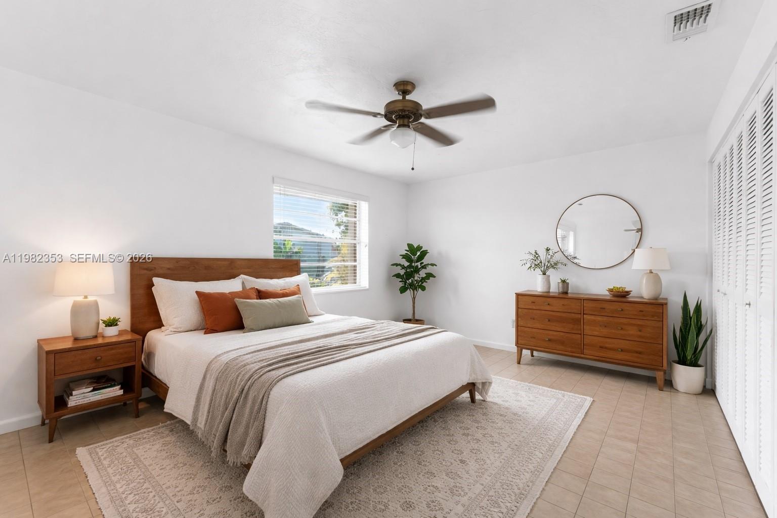 12983 Southwest 18th Terrace Miami, FL 33175 - Photo 11 of 25 a bedroom with bed and a chandelier