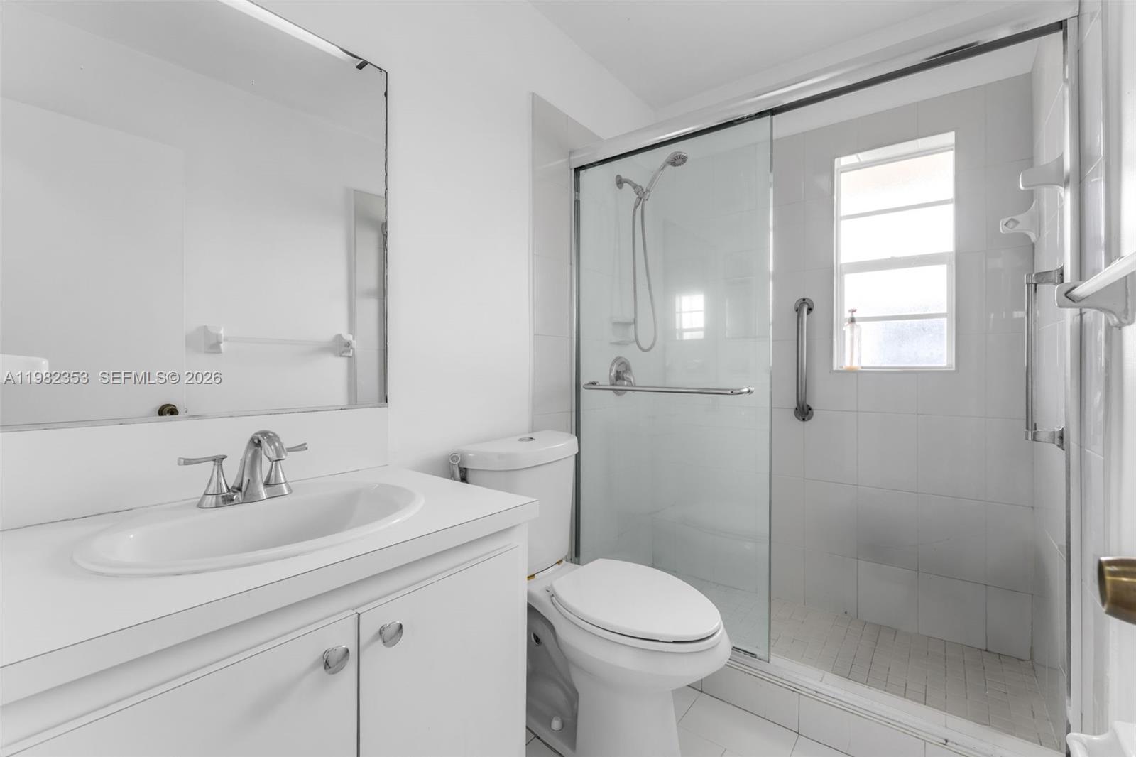 12983 Southwest 18th Terrace Miami, FL 33175 - Photo 13 of 25 a bathroom with a sink a toilet and shower