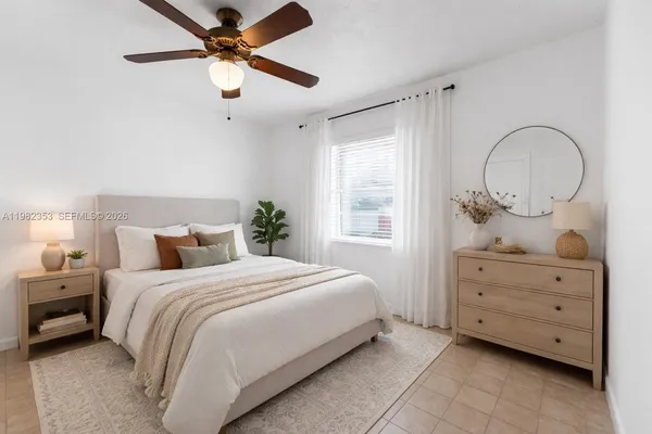 an empty room with closet and a chandelier fan