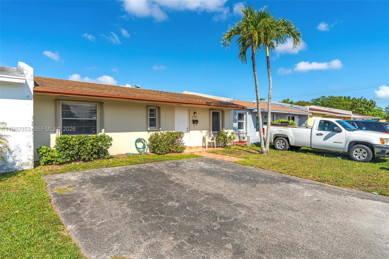 12983 Southwest 18th Terrace Miami, FL 33175 - Photo 2 of 25 a front view of a house with garden
