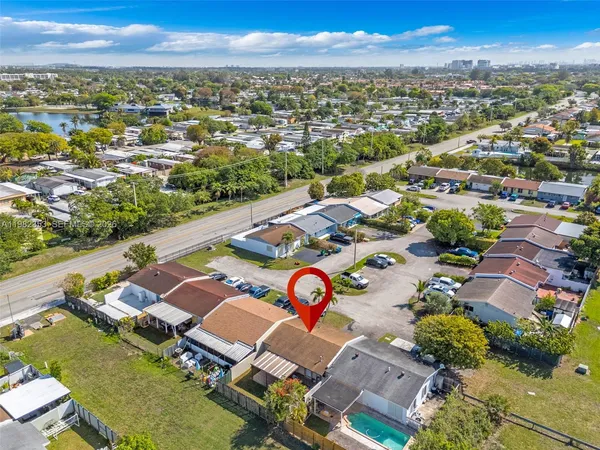 an aerial view of a house with a yard and lake view