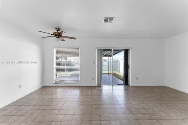 a view of a livingroom with a ceiling fan and wooden floor