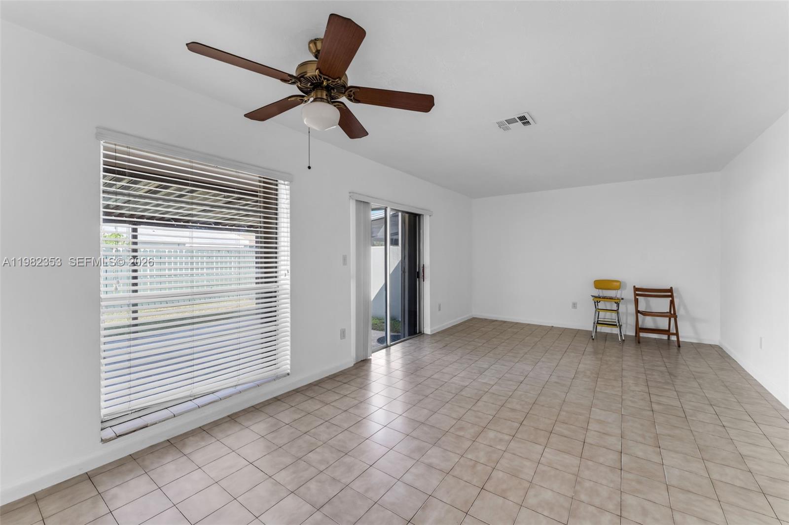 12983 Southwest 18th Terrace Miami, FL 33175 - Photo 5 of 25 a view of a livingroom with a ceiling fan and wooden floor
