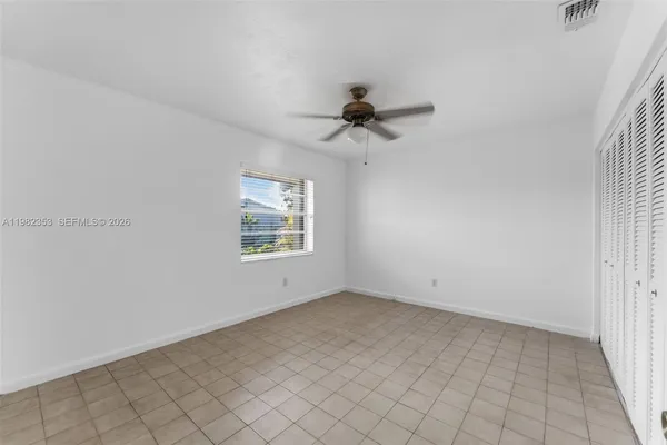 a bedroom with bed and a chandelier