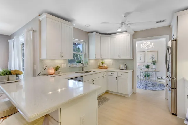a kitchen with sink refrigerator and cabinets