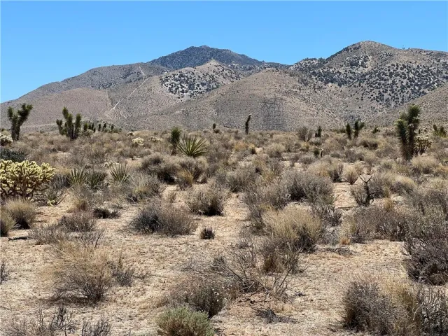 a view of a large mountain with mountain in the background