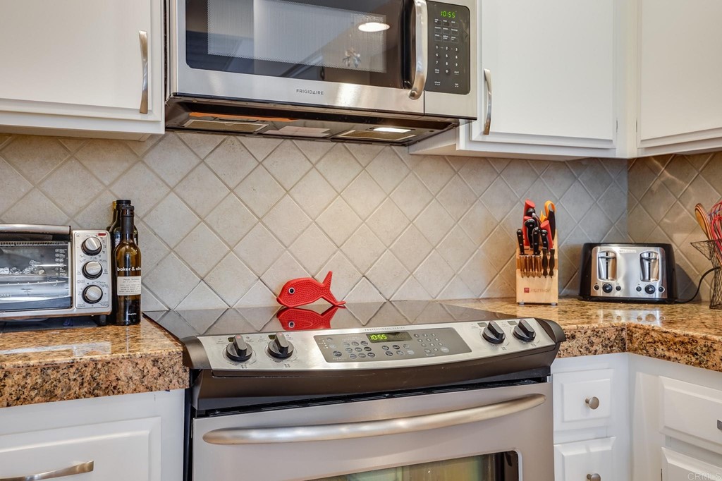 573 South Sierra Avenue, Unit 8 Solana Beach, CA 92075 - Photo 14 of 54 a kitchen with stainless steel appliances granite countertop a sink and cabinets