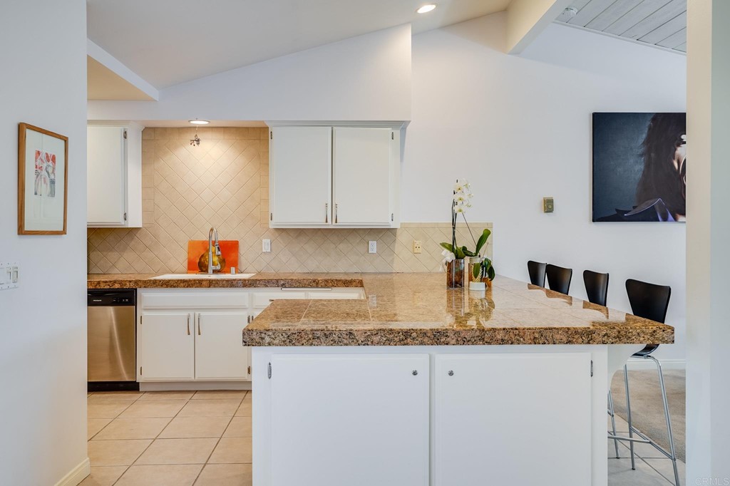 573 South Sierra Avenue, Unit 8 Solana Beach, CA 92075 - Photo 15 of 54 a kitchen with granite countertop a sink and a stove top oven