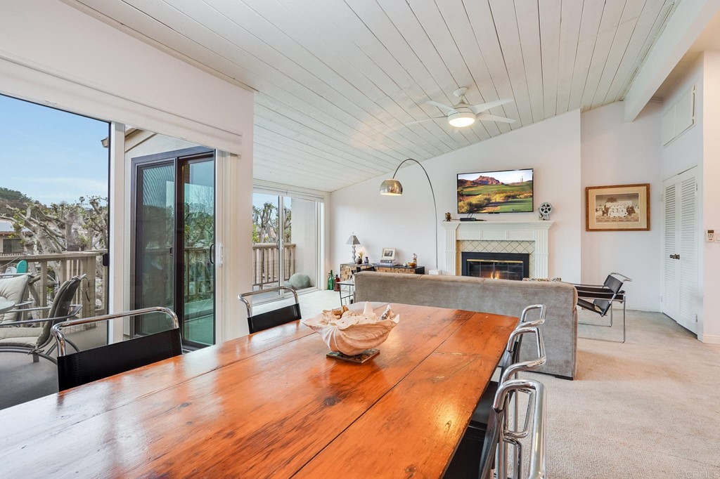 573 South Sierra Avenue, Unit 8 Solana Beach, CA 92075 - Photo 19 of 54 a view of a dining room with furniture a fireplace and wooden floor