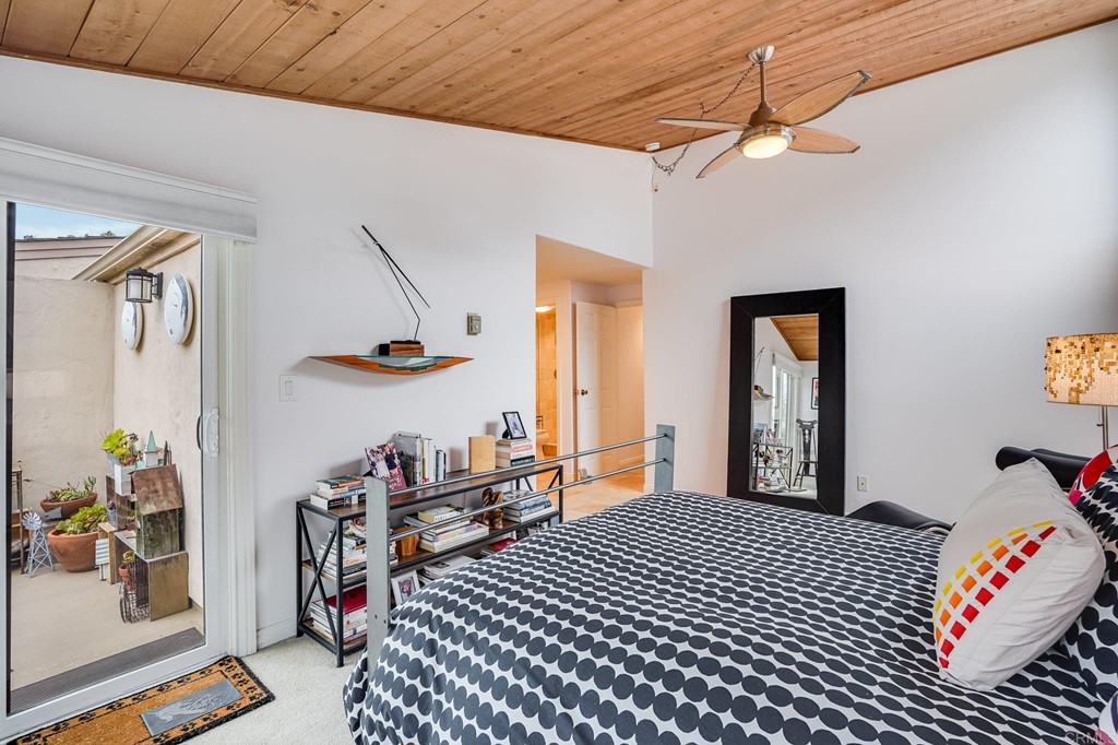 573 South Sierra Avenue, Unit 8 Solana Beach, CA 92075 - Photo 22 of 54 a bedroom with furniture and a chandelier