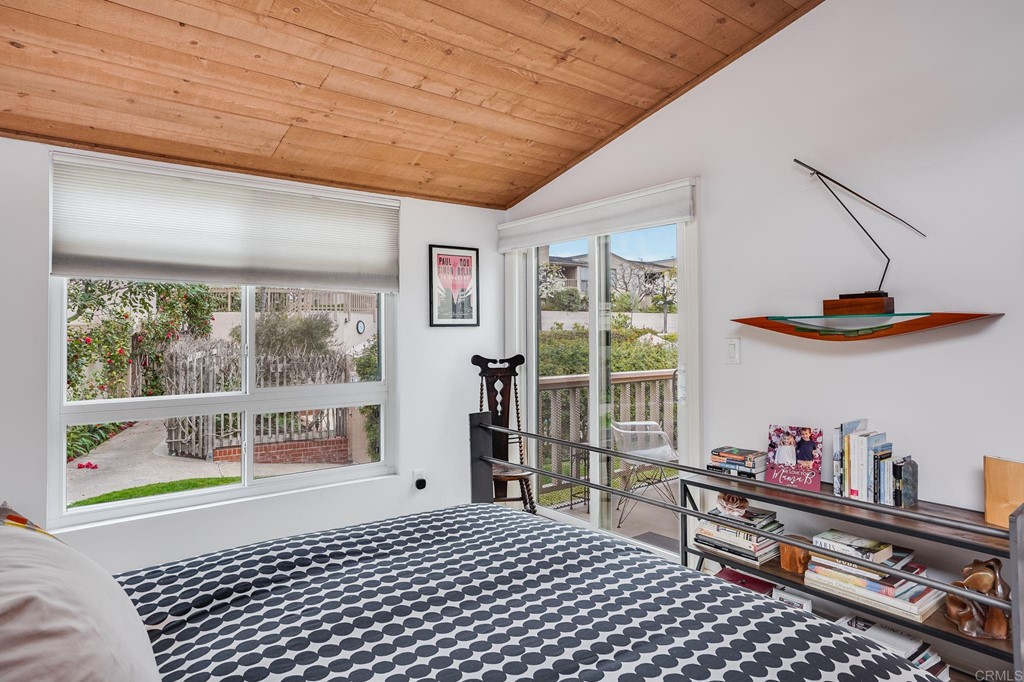 573 South Sierra Avenue, Unit 8 Solana Beach, CA 92075 - Photo 24 of 54 a bedroom with furniture and a window