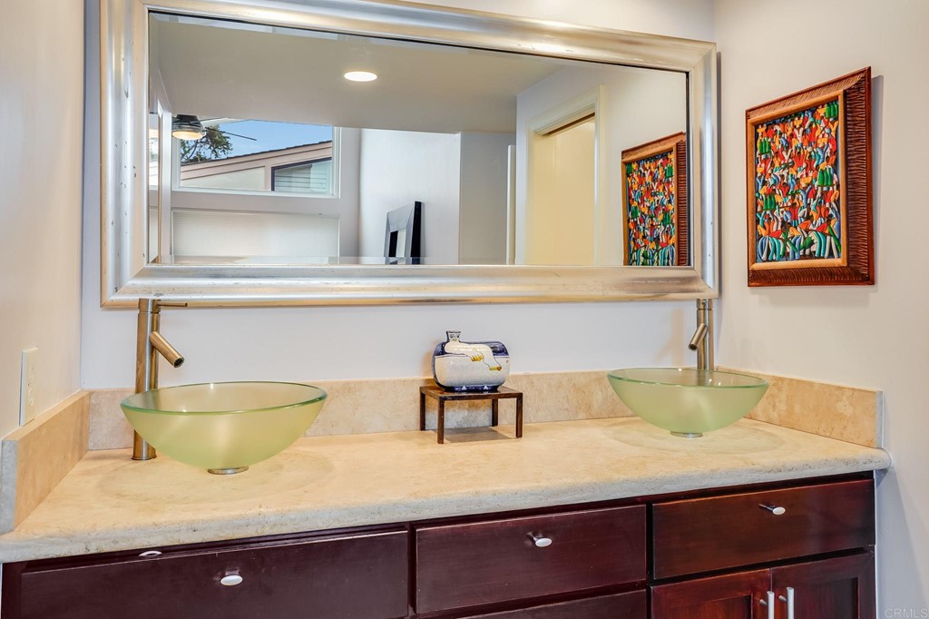 573 South Sierra Avenue, Unit 8 Solana Beach, CA 92075 - Photo 25 of 54 a bathroom with a sink and a mirror