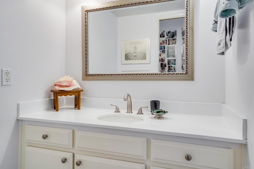 573 South Sierra Avenue, Unit 8 Solana Beach, CA 92075 - Photo 30 of 54 a bathroom with a sink and a mirror