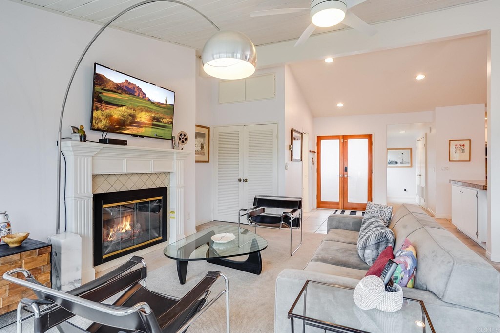 573 South Sierra Avenue, Unit 8 Solana Beach, CA 92075 - Photo 7 of 54 a living room with furniture a flat screen tv and a fireplace