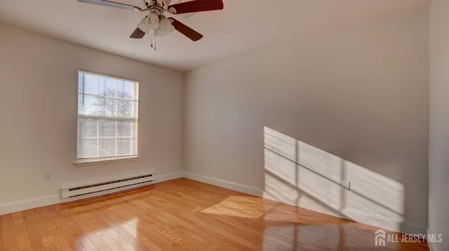 a view of empty room with ceiling fan