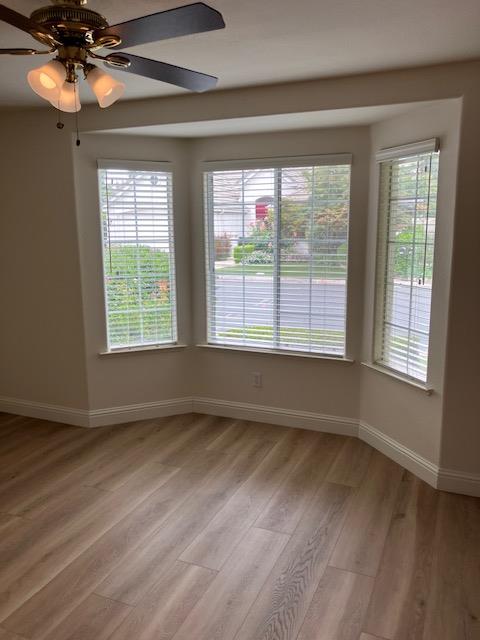 2157 West Rue St Michel Fresno, CA 93711 - Photo 17 of 22 a view of an empty room with a window and wooden floor