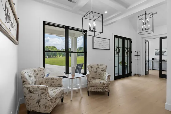 a view of a workspace with furniture and a bookshelf