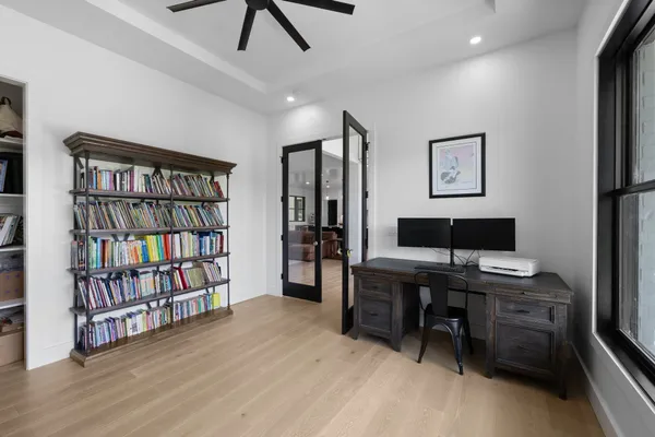 a kitchen with stainless steel appliances granite countertop a table chairs a sink and a refrigerator