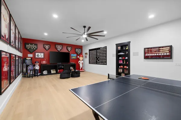 a bedroom with a large bed and a painting on the wall